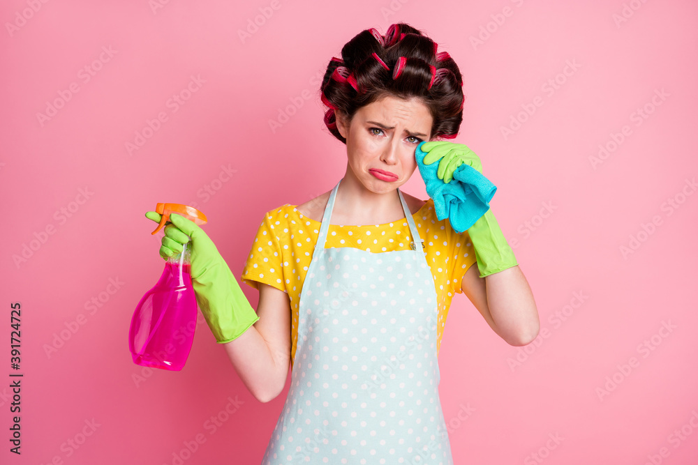 Portrait of depressed wife hold rag bottle spray cry wear yellow t-shirt rubber gloves isolated pastel color background Portrait of depressed wife hold rag bottle spray cry wear yellow t-shirt rubber gloves isolated pastel color background