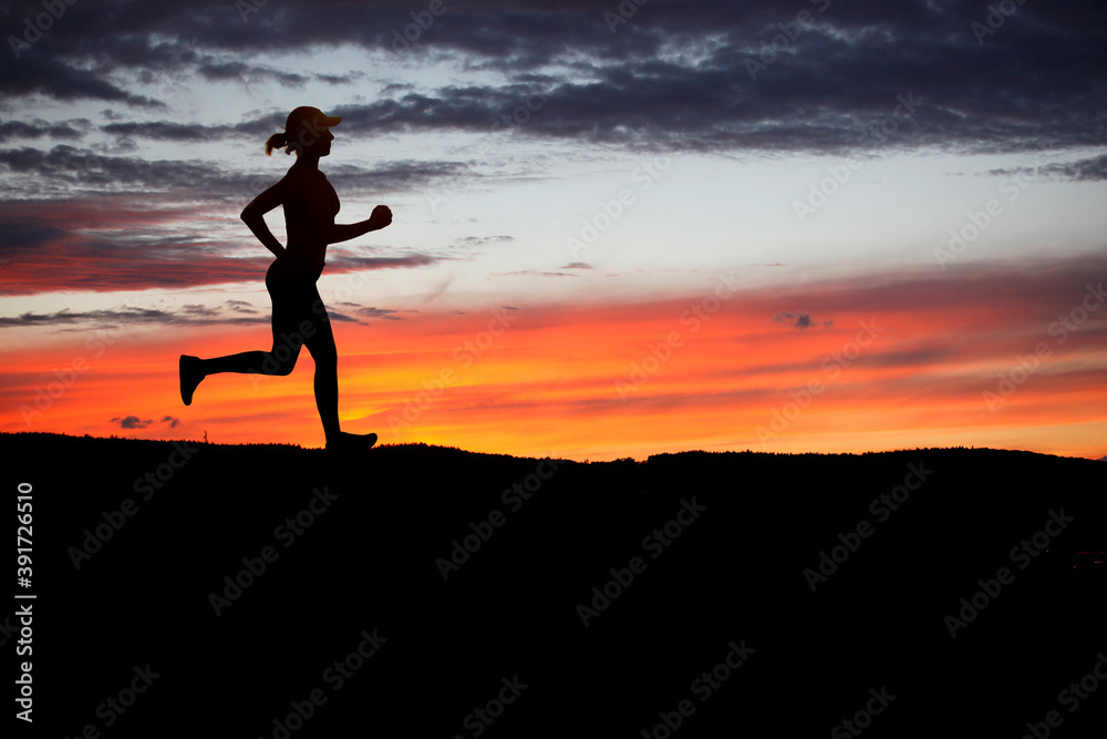 Runner during sunset - fitness work out concept