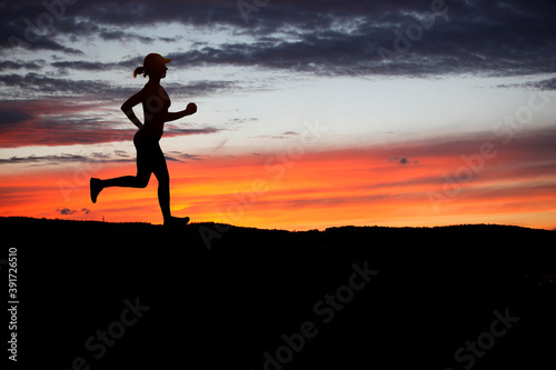 Runner during sunset - fitness work out concept © semisatch
