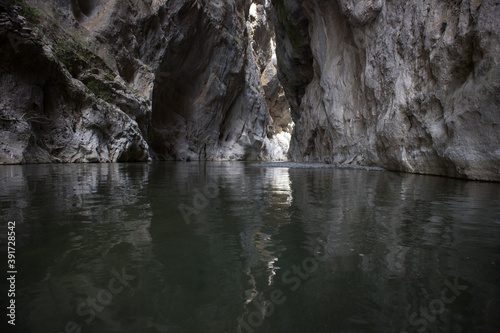 Breathtaking Venetikos river in Portitsa Gorge. Characterized by the high cliffs of 150-200 meters. Picture taken with a small tripod on the surface of the water.