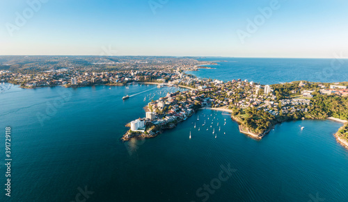 Aerial evening view of Manly, a suburb of northern Sydney in New South Wales, Australia. Little Manly & Collins Beach in the foreground, Manly Harbour, Manly Beach and Northern Beaches in background.