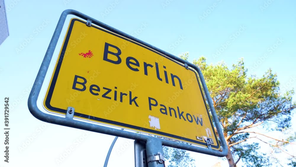 Close Up of Yellow Berlin City Sign under Blue Sky in Pankow District Close Up of Yellow Berlin City Sign under Blue Sky in Pankow District