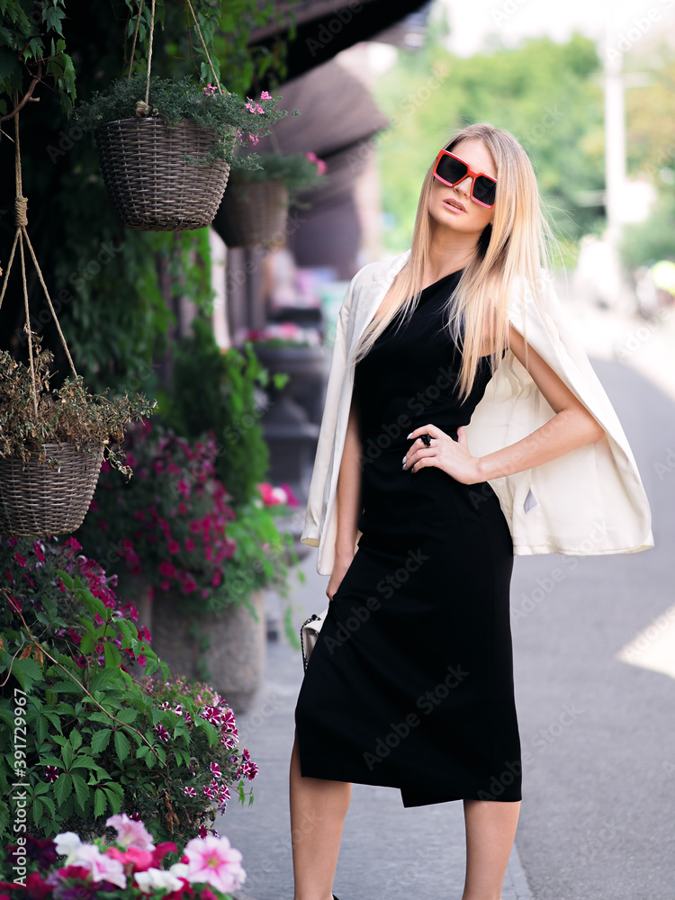 Elegant blonde girl posing on the street