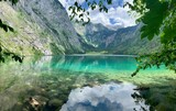 Breathtaking view of green turquoise crystal clear alpine lake Obersee Koenigssee surrounded by mountains Alps in Bavaria, Germany
