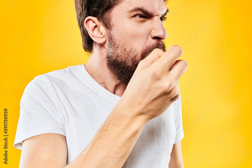 Fototapeta premium bearded man gesturing with hands studio lifestyle discontent yellow background