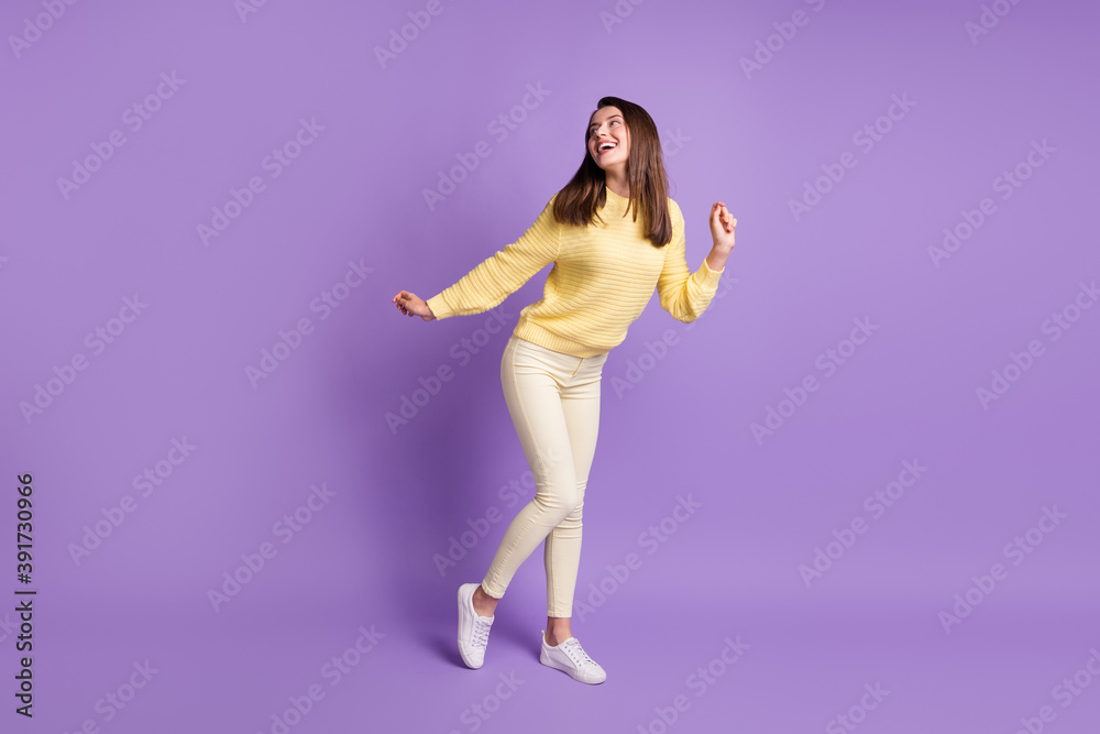 Photo portrait full length of attractive girl dancing looking back isolated on vivid violet colored background