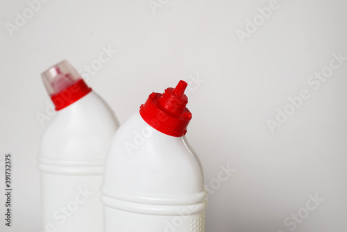 Cleaning agent or disinfectant in white bottles on a white background photo