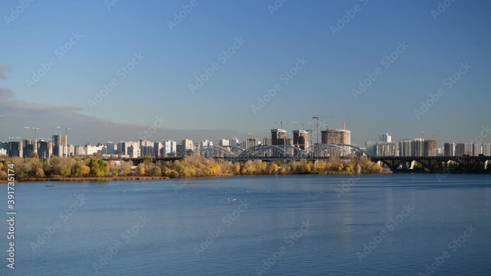 Nice evening panoramic view of Dnipro river with island Ostriv Malyy and bridge from Paton bridge in Kiev, Ukraine