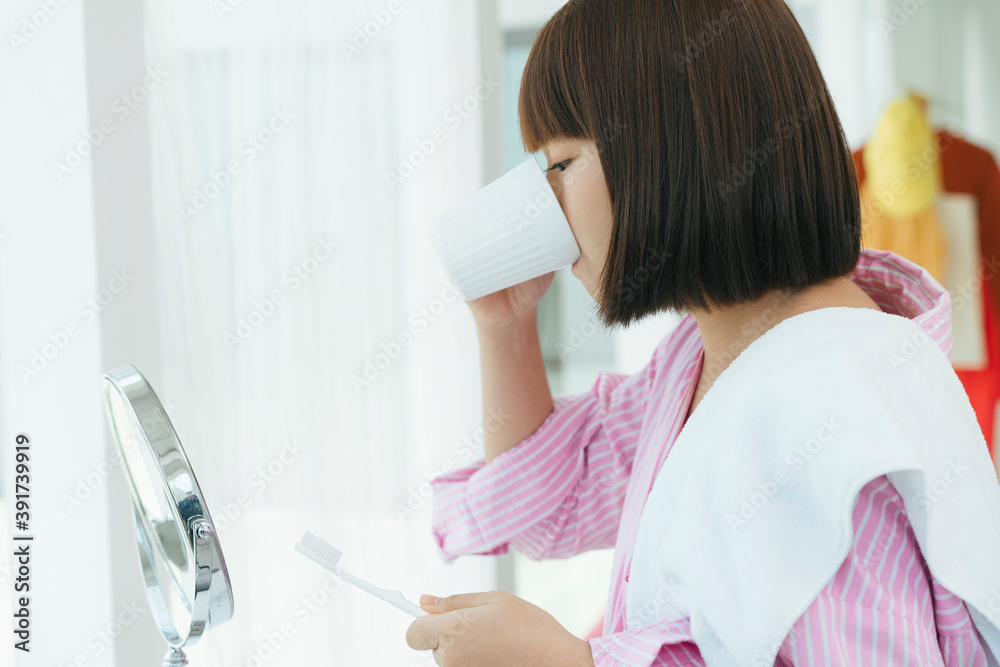 Young asian thai bob hairstyle woman brushing teeth with toothbrush in restroom. Young asian thai bob hairstyle woman brushing teeth with toothbrush in restroom.
