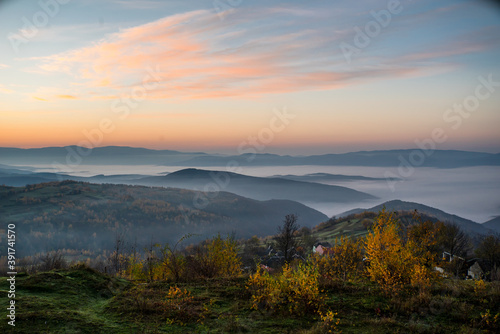 sunrise on a background of mountains in the fog. autumn season.