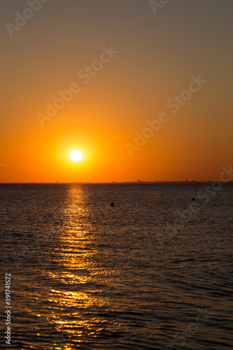 people on the seashore during sunset © antonsov85