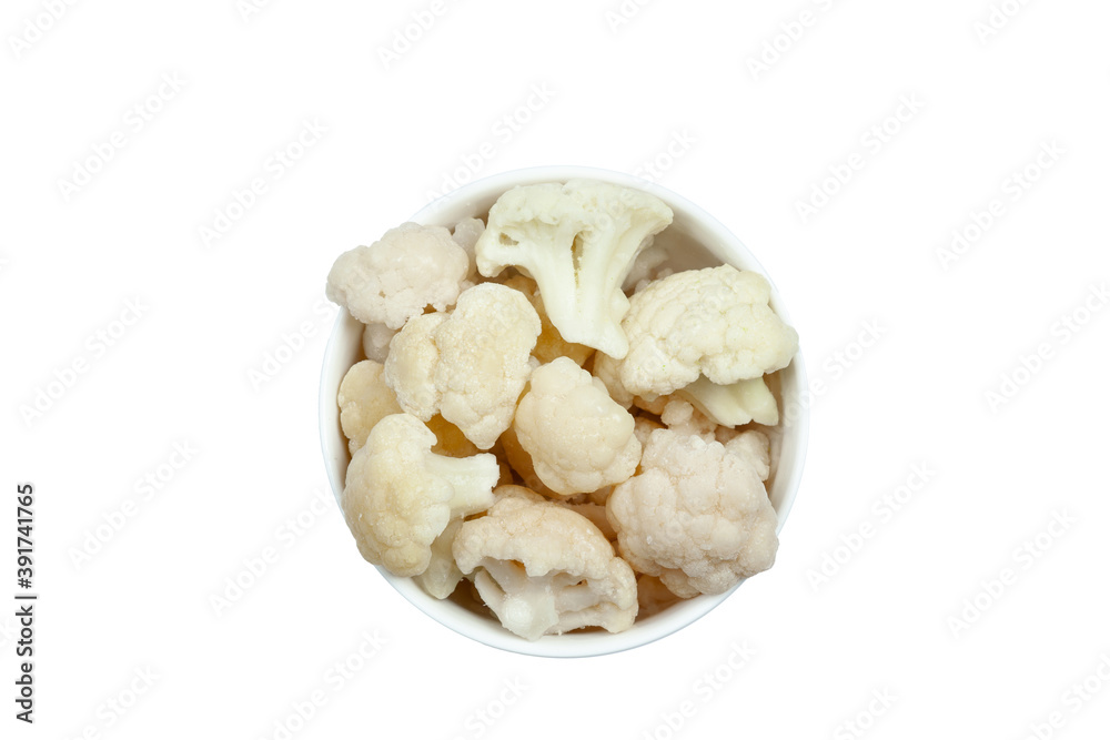 Frozen cauliflower florets in a bowl isolated on white backgroung, top view