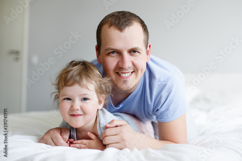 family and father's day concept - happy young father and his cute little daughter having fun