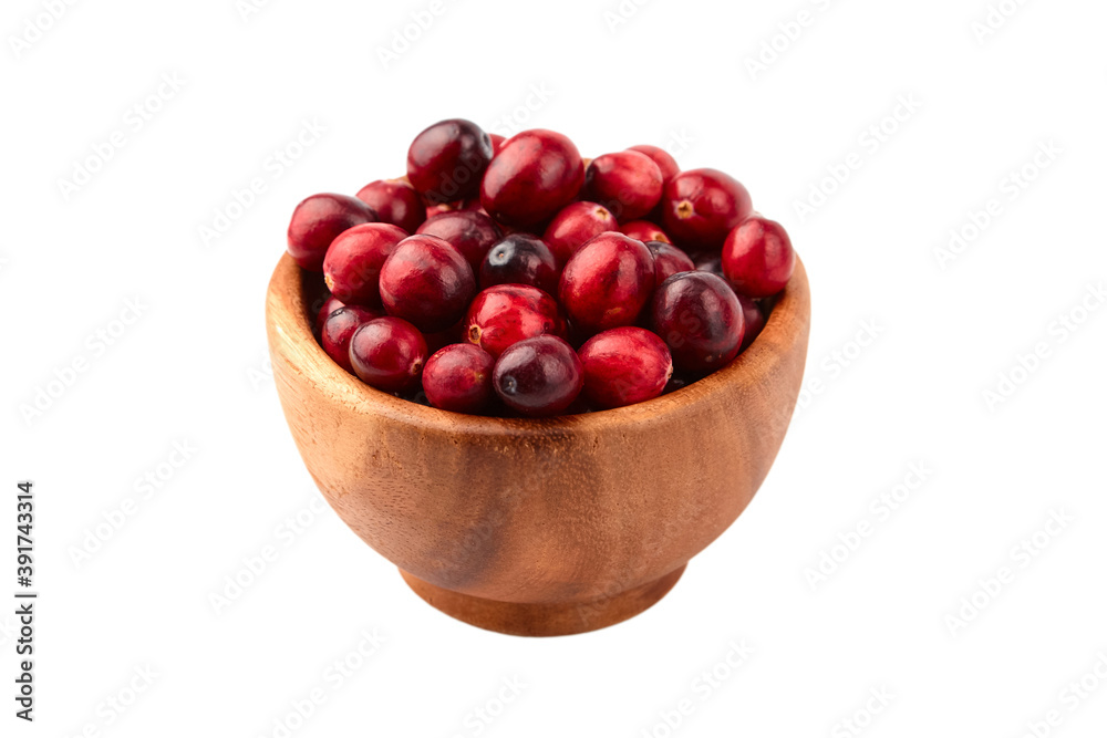 Cranberries in wooden bowl isolated on white Cranberries in wooden bowl isolated on white