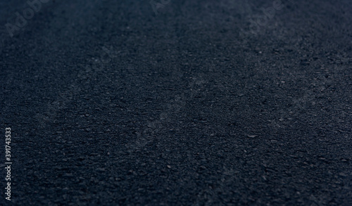 Texture details of surface of asphalt on new road with vignette.