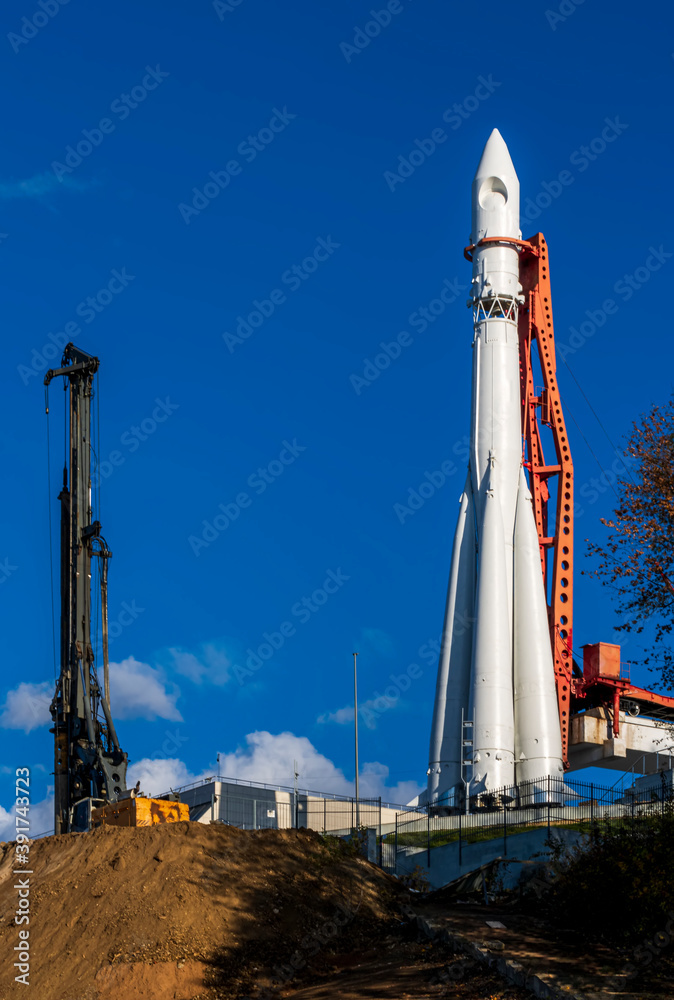 construction machinery and architectural engineering on a construction site, cran and drilling rig on a building rocket launch facility construction machinery and architectural engineering on a construction site, cran and drilling rig on a building rocket launch facility