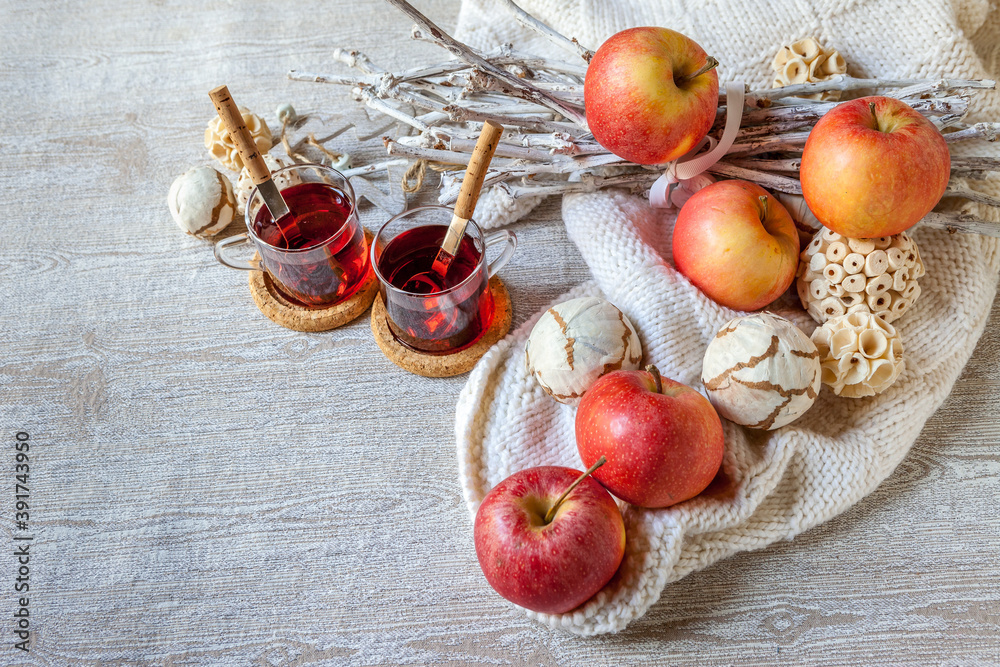 two cups of hot mulled wine with red apples and white blanket two cups of hot mulled wine with red apples and white blanket