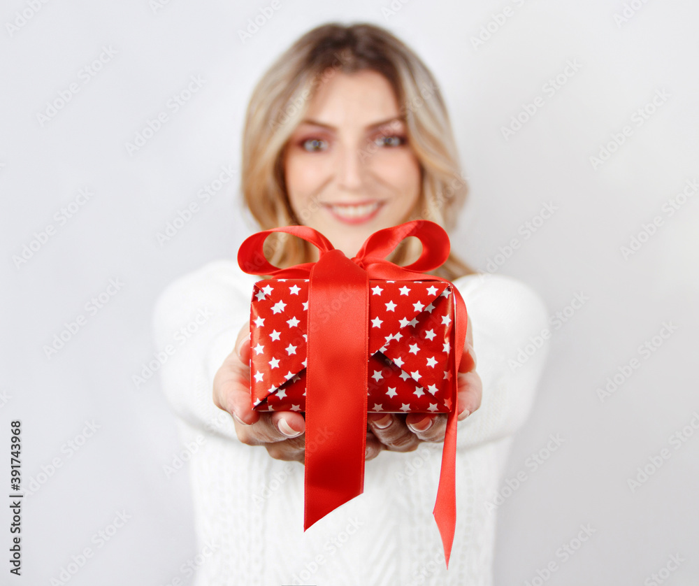Smiling young woman holding present Smiling young woman holding present