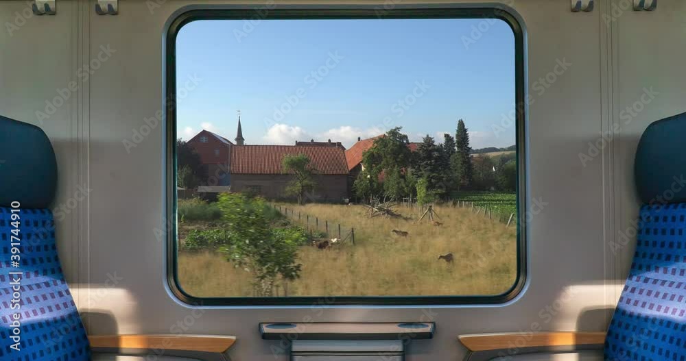 An empty blue seat in europe german train with window corn field display nature summer view on the railway road transportation during coronavirus 