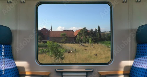 An empty blue seat in europe german train with window corn field display nature summer view on the railway road transportation during coronavirus 