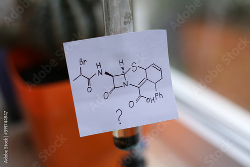 The chemical structure of an unknown organic compound, possibly an antibiotic, on a white sticker. photo