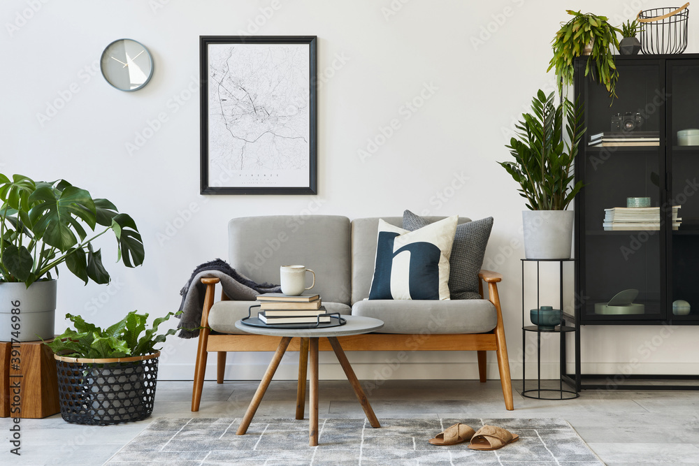 Modern retro concept of home interior with design grey sofa, coffee table,  plants, furniture, mock up poster map, decoration and personal accessoreis.  Stylish home decor of living room. Photos | Adobe Stock