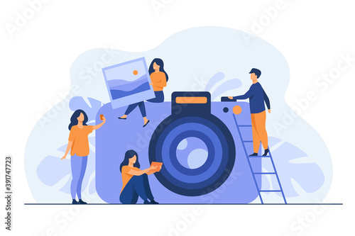 Tiny people and large photo camera isolated flat vector illustration. Cartoon characters making selfie and holding full picture. Photography courses and artistic occupation concept