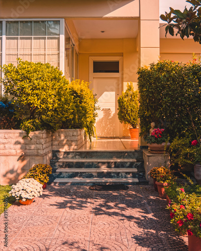stylish family house front corridor through the garden to the main entrance door