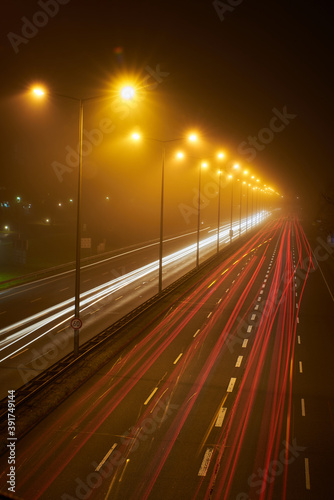 Long exposure of a busy street at night. Foggy street at night.