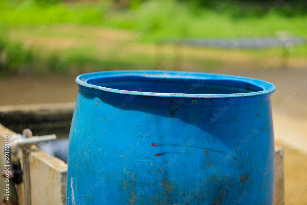 empty plastic drum in farm for water storage
