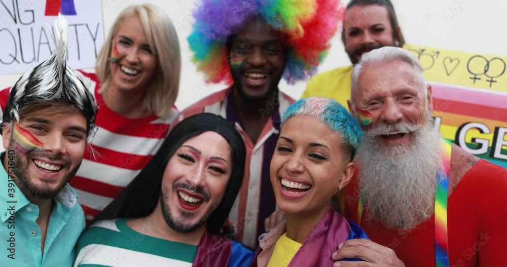 Happy gay people laughing in front of camera at lgbt pride party Happy gay people laughing in front of camera at lgbt pride party