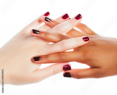 two different nathion manicured hands on white isolated, african with caucasian