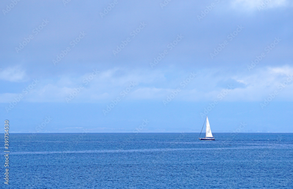 Seascape and Tranquil scene of white  sailboat on the ocean with blue ocean and cloud blue sky  - blue nature backdrops - Monterey USA