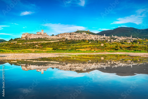 Assisi town skyline and reflection on the water. Perugia, Umbria, Italy.
