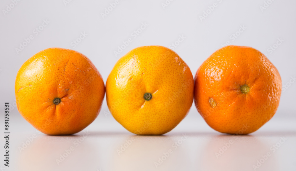 appetizing tangerines laid out in a row on white background appetizing tangerines laid out in a row on white background