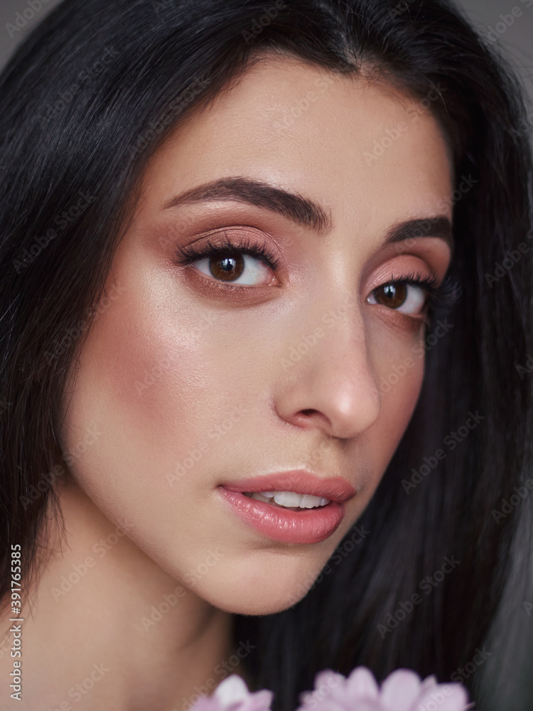 Obraz premium Magnificent portrait of a beautiful brunette young woman with perfect skin makeup closeup