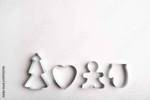 Christmas minimal white background. cookie cutters tree, heart, mitten, gingerbread man.