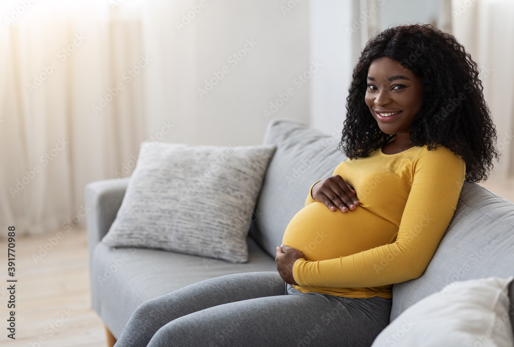 Happy african expecting lady spending time at home, copy space Happy african expecting lady spending time at home, copy space