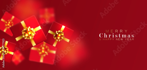 Gift box with motion blur effect. Merry Christmas and Happy New year. Realistic background with voluminous red gifts tied with a gold ribbon with bows. The view from the top. Horizontal arrangement.