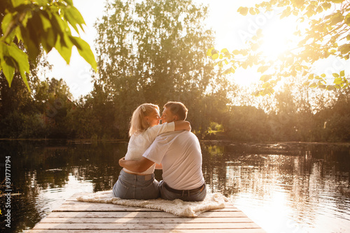 A man and a woman sit on the dock