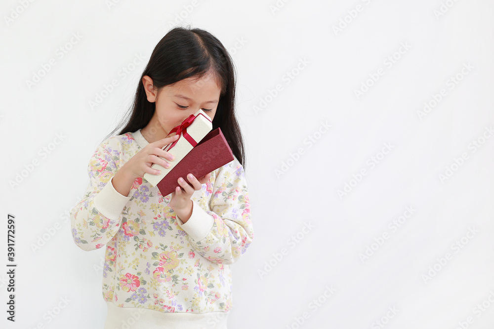 Excited little asian kid girl with gift box on white background Excited little asian kid girl with gift box on white background