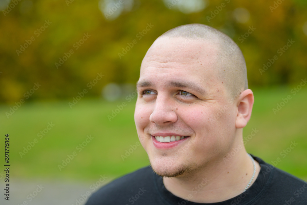 Young man looking up with a pleased smile Young man looking up with a pleased smile