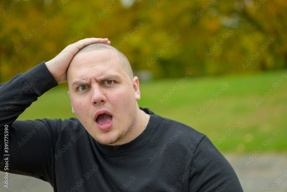 Young man staring at camera with aghast expression Young man staring at camera with aghast expression