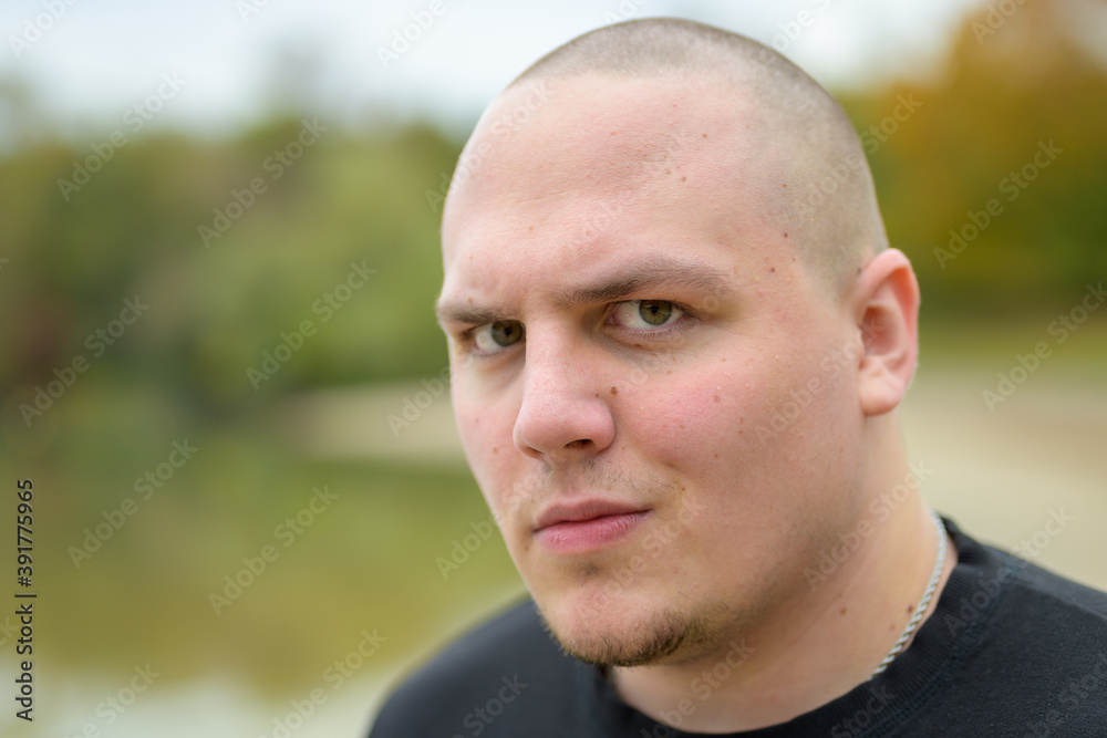 Sceptical young man looking sideways at the camera Sceptical young man looking sideways at the camera