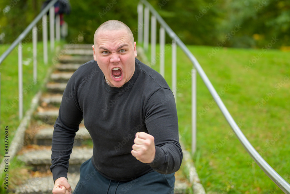 Angry man threatening the camera with his fist Angry man threatening the camera with his fist