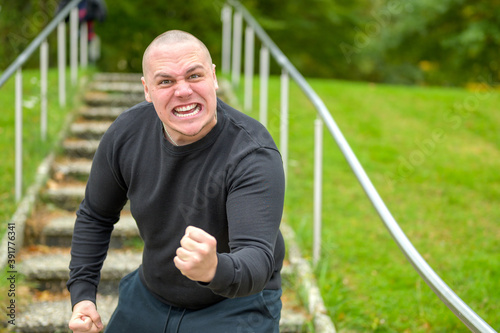 Angry man threatening the camera with his fist