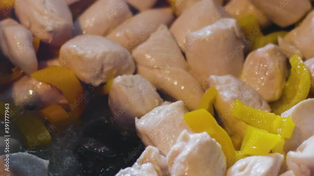 Raw Chicken And Peppers Sizzling In Pan
