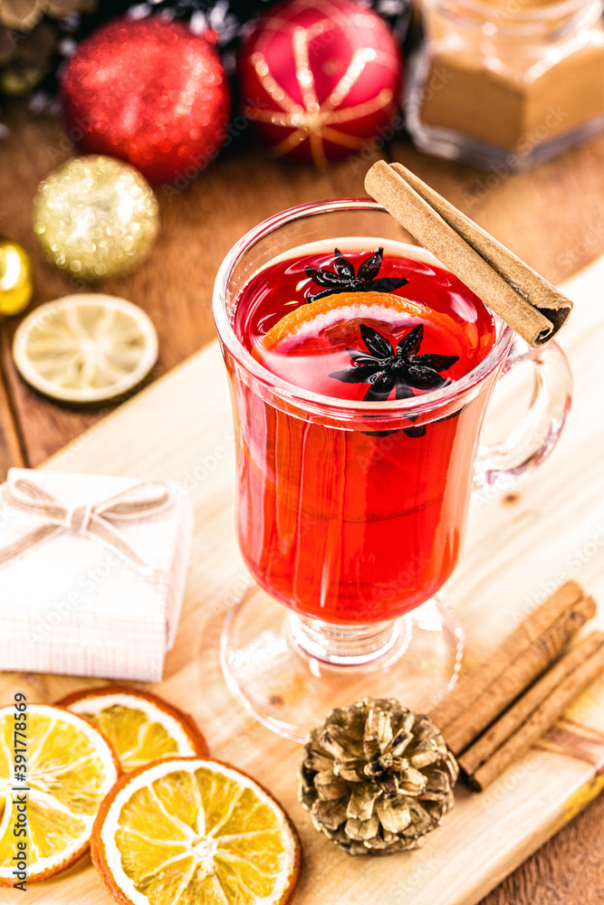 Mulled wine in glass cups with spices and citrus fruits, rustic table in the background, year-end tradition Mulled wine in glass cups with spices and citrus fruits, rustic table in the background, year-end tradition