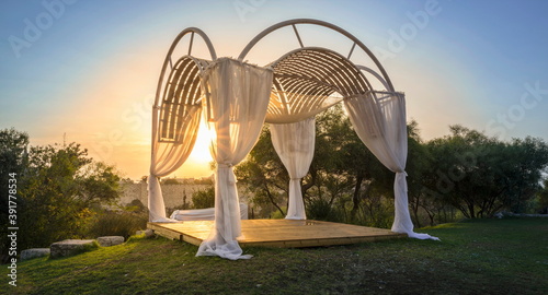 Chuppah - a traditional wedding canopy under which a Jewish couple stand during their wedding ceremony - on a green hillside in Jerusalem Israel