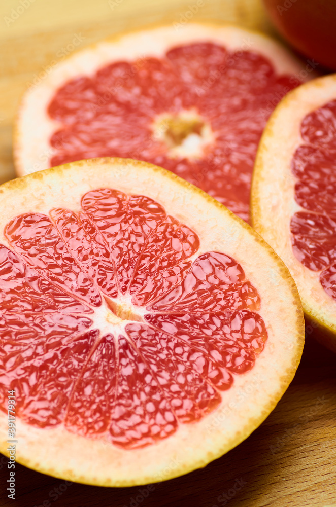 sliced juicy red grapefruit close up, vertically sliced juicy red grapefruit close up, vertically